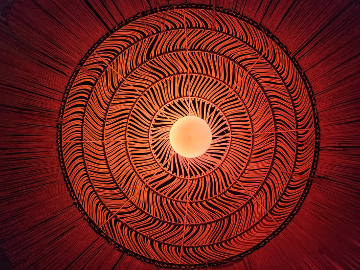 Photo of a lamp shade from below with beautiful patterns highlighted