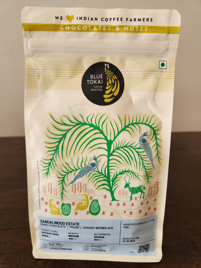 Photo of a coffee pouch with a beautiful design containing roasted coffee from Sandalwood Estate Coorg India