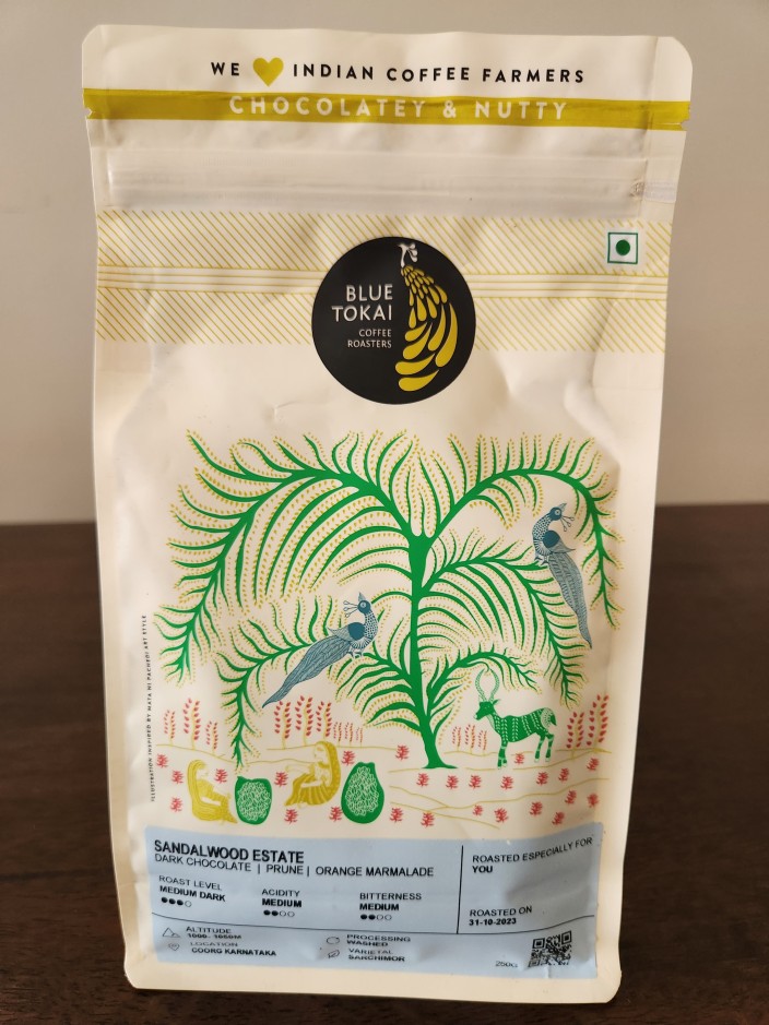 Photo of a coffee pouch with a beautiful design containing roasted coffee from Sandalwood Estate Coorg India Photo of a coffee pouch with a beautiful design containing roasted coffee from Sandalwood Estate Coorg India